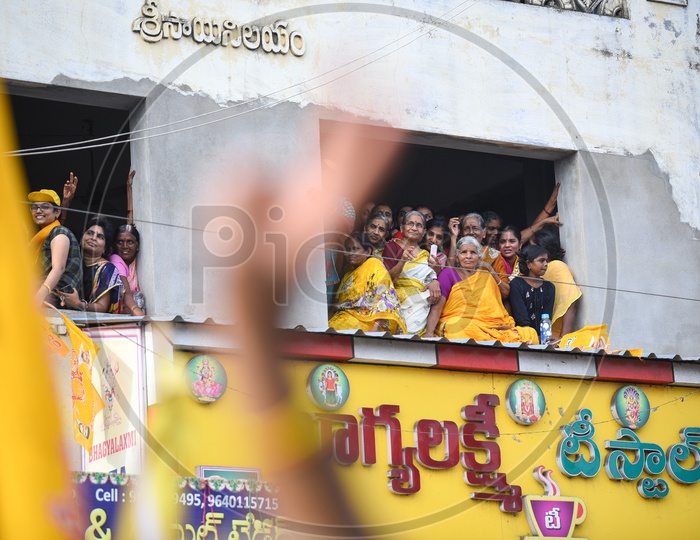 Woman  TDP Party Supporters Sitting On a Building Pit Wall and  Listening Curiously to Speech