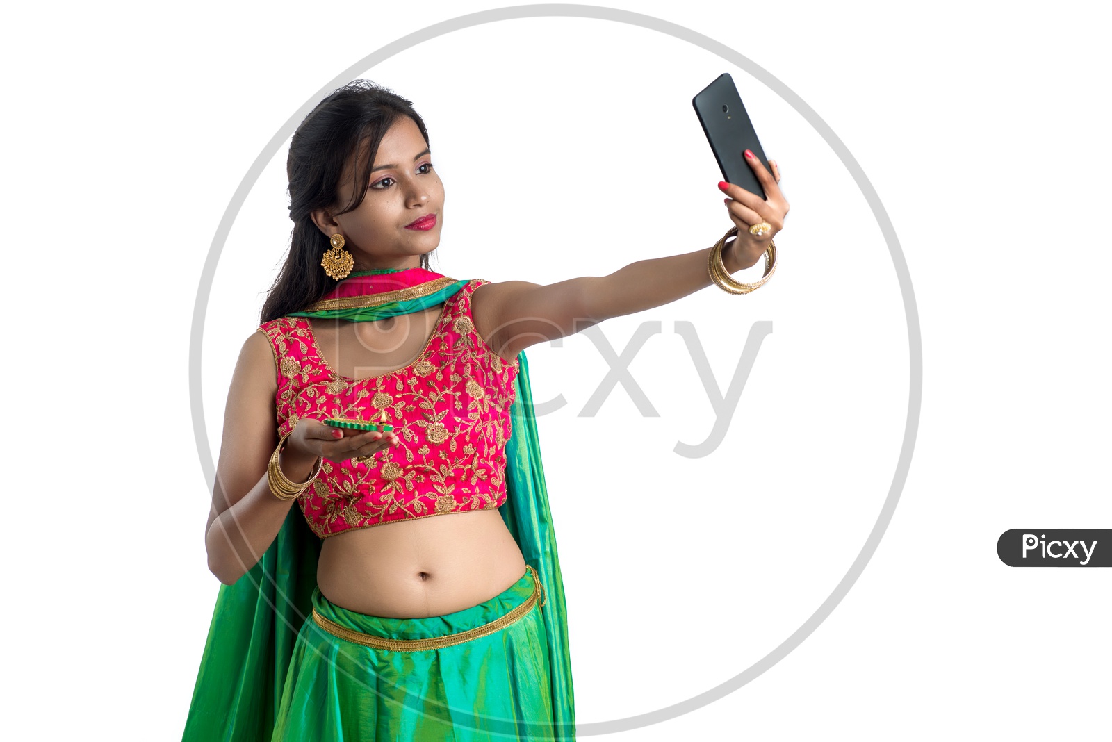 Portrait Of a Young Indian Traditional Woman Holding Dia in Hand and  Taking Selfie in Smart Phone  Over  Isolated White Background