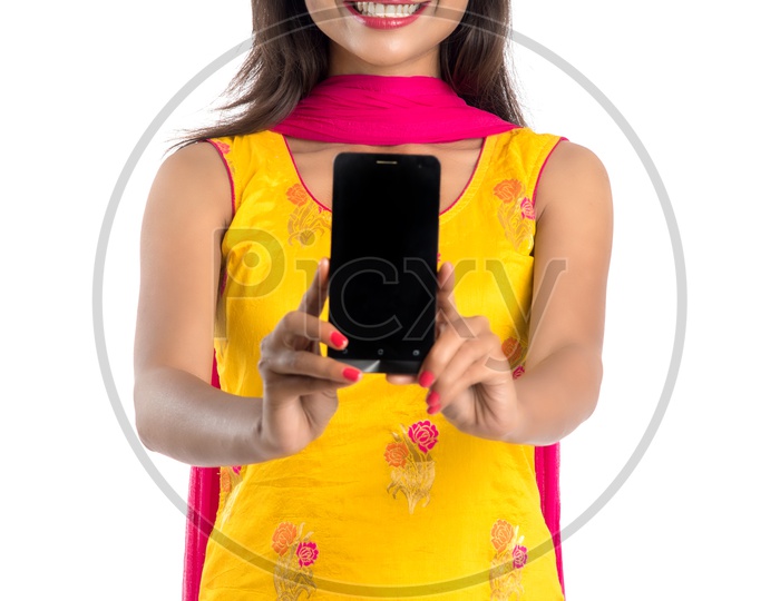Beautiful Indian Girl Showing Smart Phone Screen With a Smile On Face