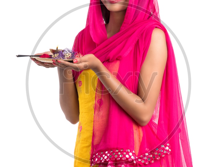 Beautiful Indian Girl Holding  Pooja Thali  Or Pooja Plate In Hand And Performing Worship