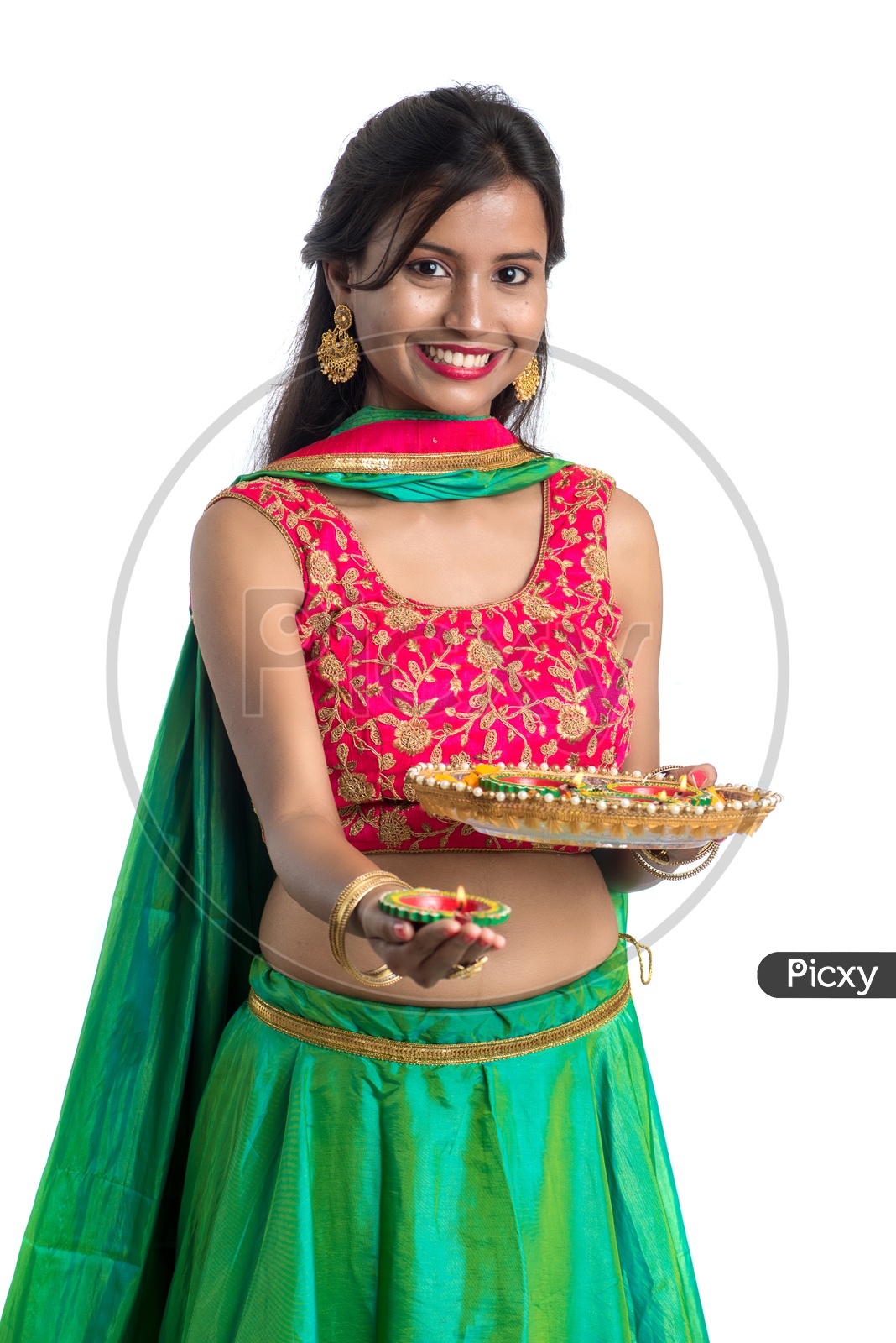 Portrait of a Young Indian Traditional Girl  Holding  Dia Plate And  Dia In Hand  Over an Isolated White Background