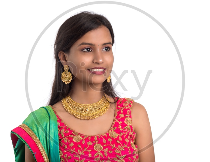 Portrait  of a Happy  Young  Indian Traditional Woman  Over a  White  Background