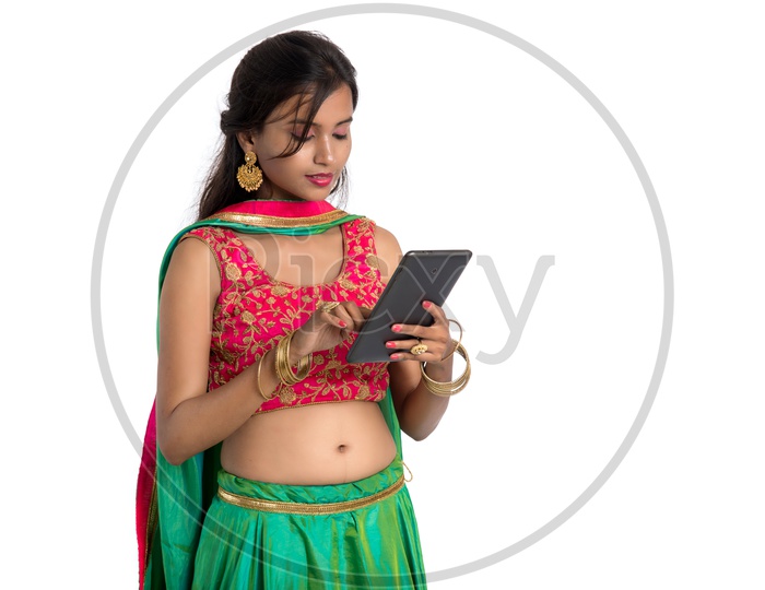 Portrait Of a beautiful Traditional Indian Woman Looking at a Smart Phone And  With a Smile Face