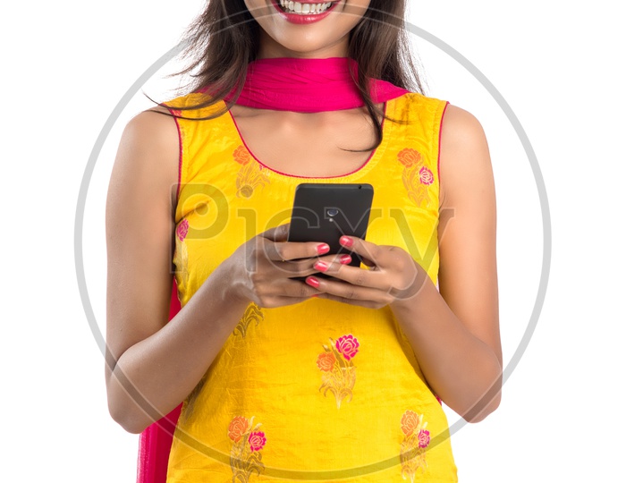Beautiful Indian Girl Looking at a Smart Phone With an Expression on Face