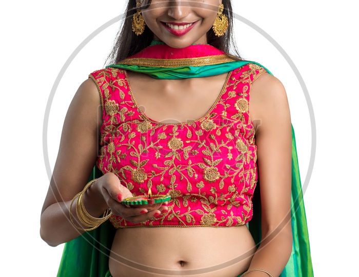 Portrait Of a Young Traditional Indian Woman Holding Festival Dia in Hand over a White Isolated Background