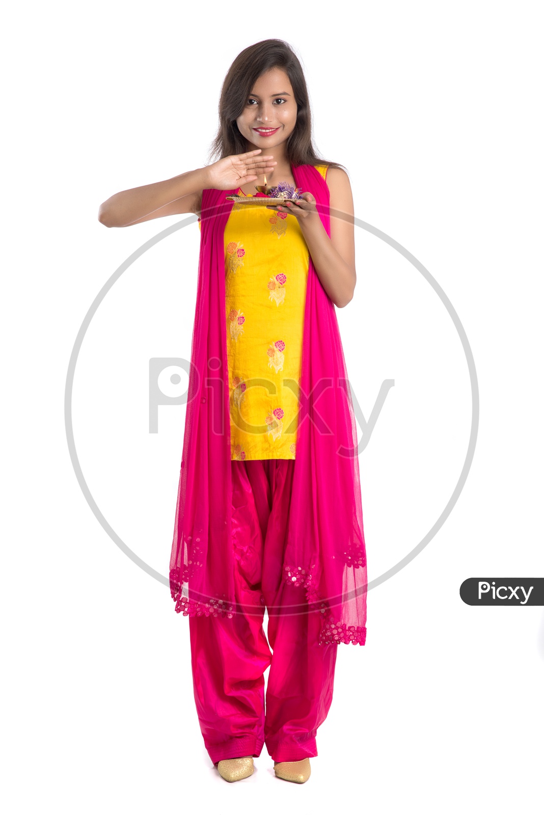 Beautiful Indian Girl Holding  Pooja Thali  Or Pooja Plate In Hand and performing Worship