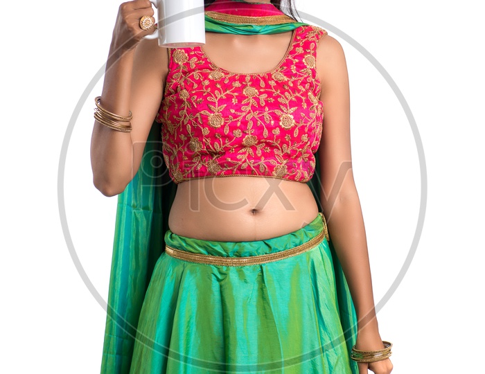 Portrait Of a Young Indian  Traditional Girl Enjoying a Cup of Tea Or Coffee Over a White Background