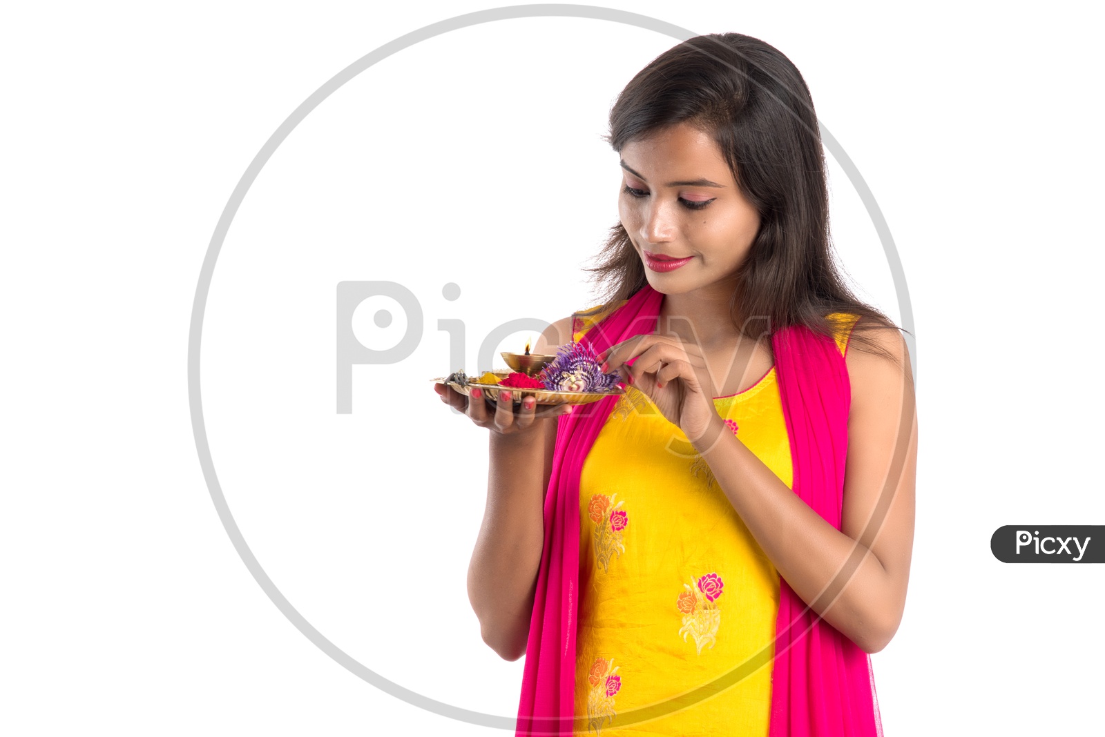 Beautiful Indian Girl Holding  Pooja Thali  Or Pooja Plate In Hand and performing Worship