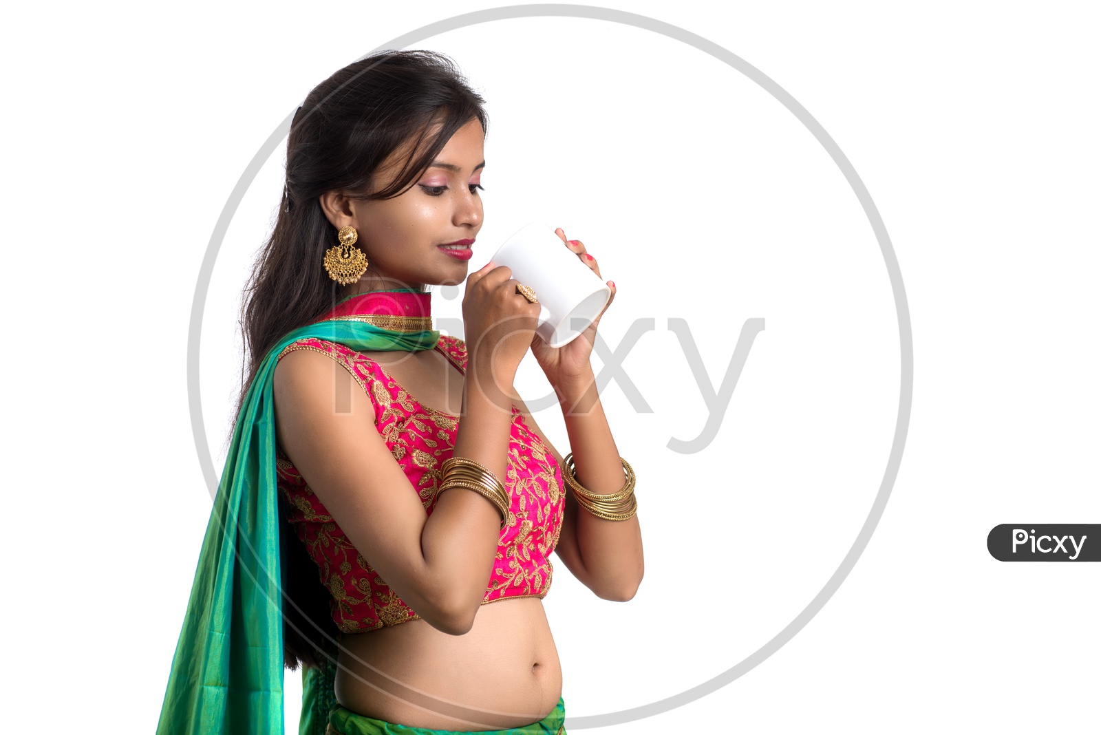 Portrait Of a Young Indian  Traditional Girl Enjoying A Cup Of Tea Or Coffee Over a White Background