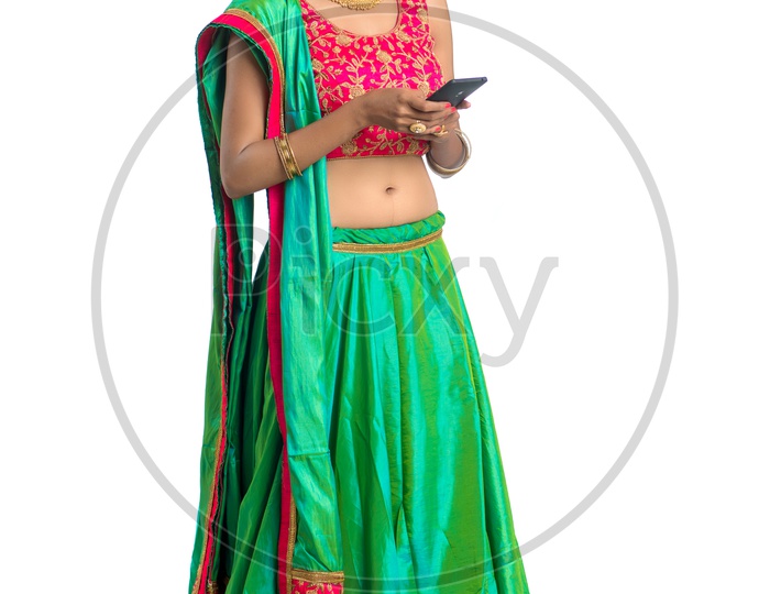 A Happy Indian Traditional Woman Using Smart Phone With Smiling Face