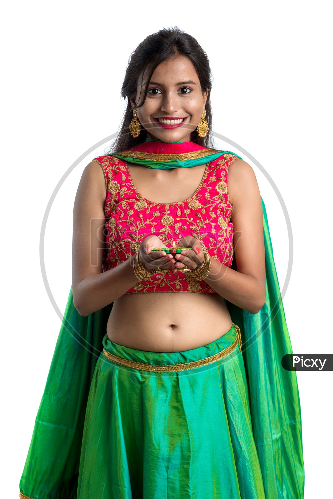 Portrait Of a Young Indian Traditional Girl Holding Festival Dia In Hand  Over a White Background