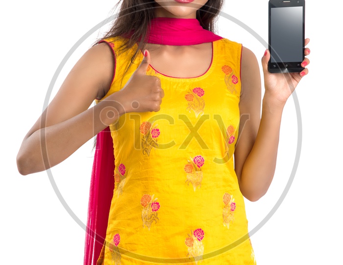 Image Of Beautiful Young Indian Girl Showing Mobile Screen With Smile 