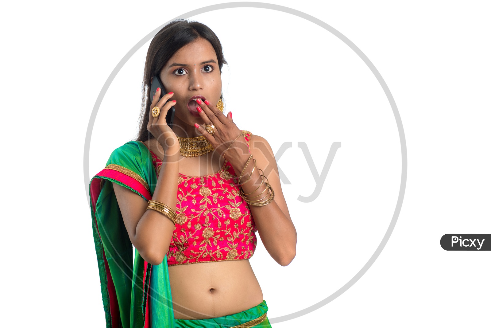 Portrait Of a Young Traditional Indian Woman Speaking In Smart phone With an Expression  Over A White Background
