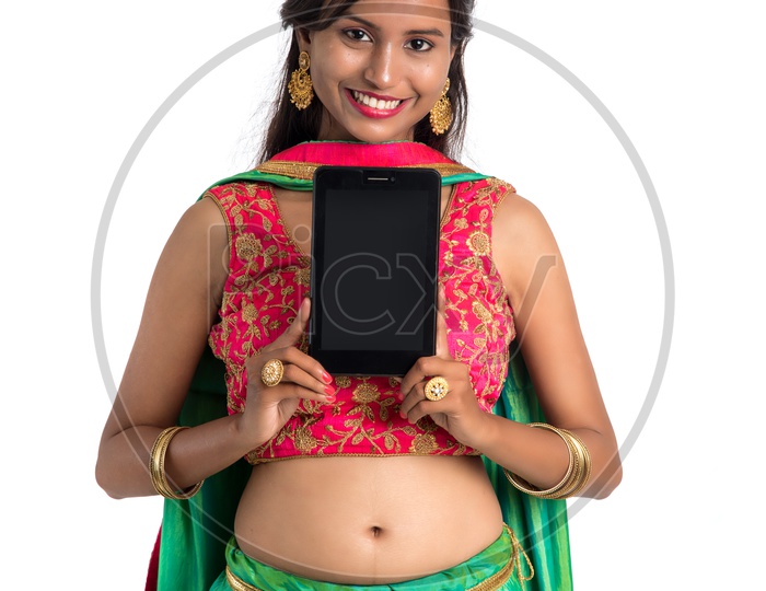 Beautiful Traditional Indian Girl Showing Smart Phone Screen with a Smile on Her Face