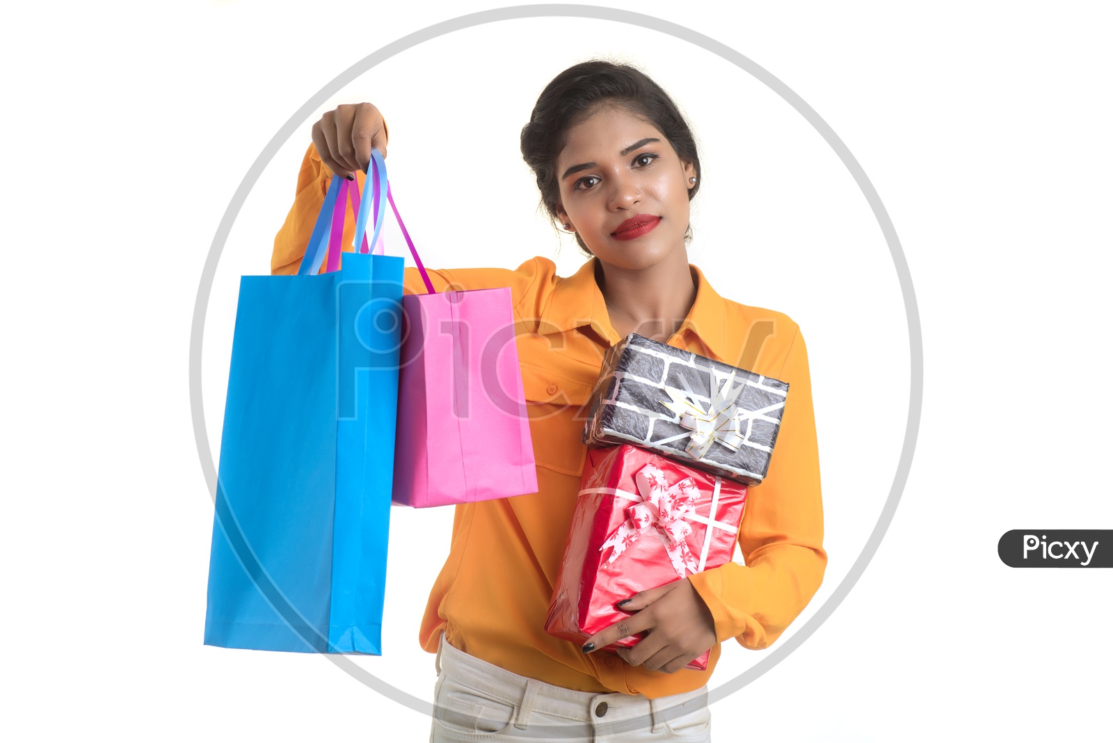 A Happy Young  Indian Girl Holding Gift Boxes and Bags in Hand And With a Smile Face on an Isolated White Background