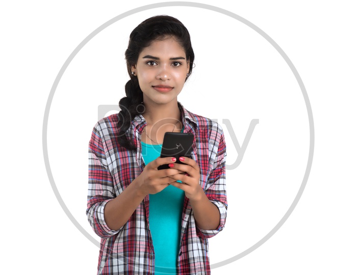 Young Pretty Indian Girl Using Smart Phone On an Isolated White Background