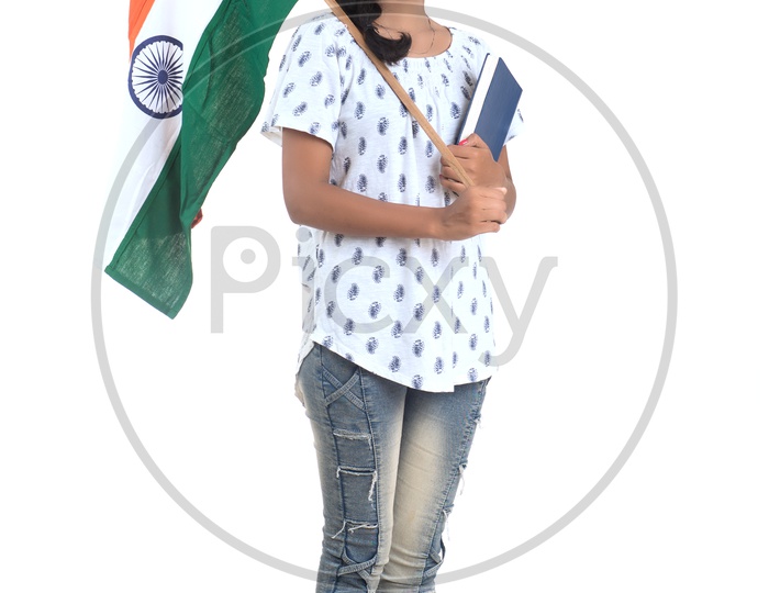 Young Indian Girl Holding Indian national Flag or Tri color Flag  and books in hands And Posing Over a White Background