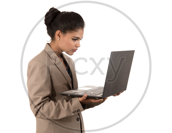 Young Indian business woman holding a laptop