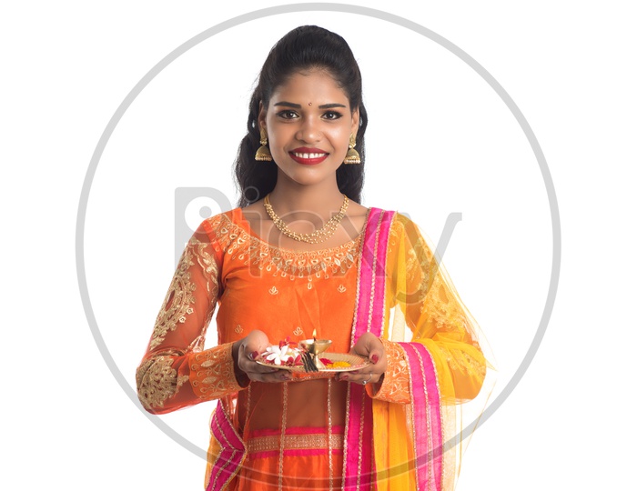 A Young Indian Traditional Woman With Pooja Thali Or Pooja Plates Holding In Hand With Smile Face On an Isolated White Background