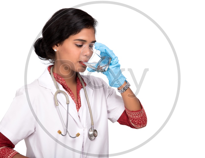 Indian Female Doctor drinking a glass of water