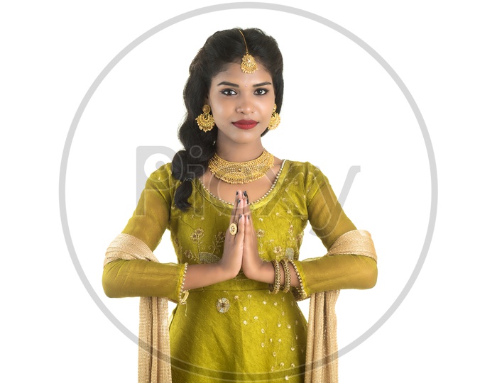 Portrait Of a Beautiful Young woman In Elegant Look with Namaste Gesture  and Posing Over White Background