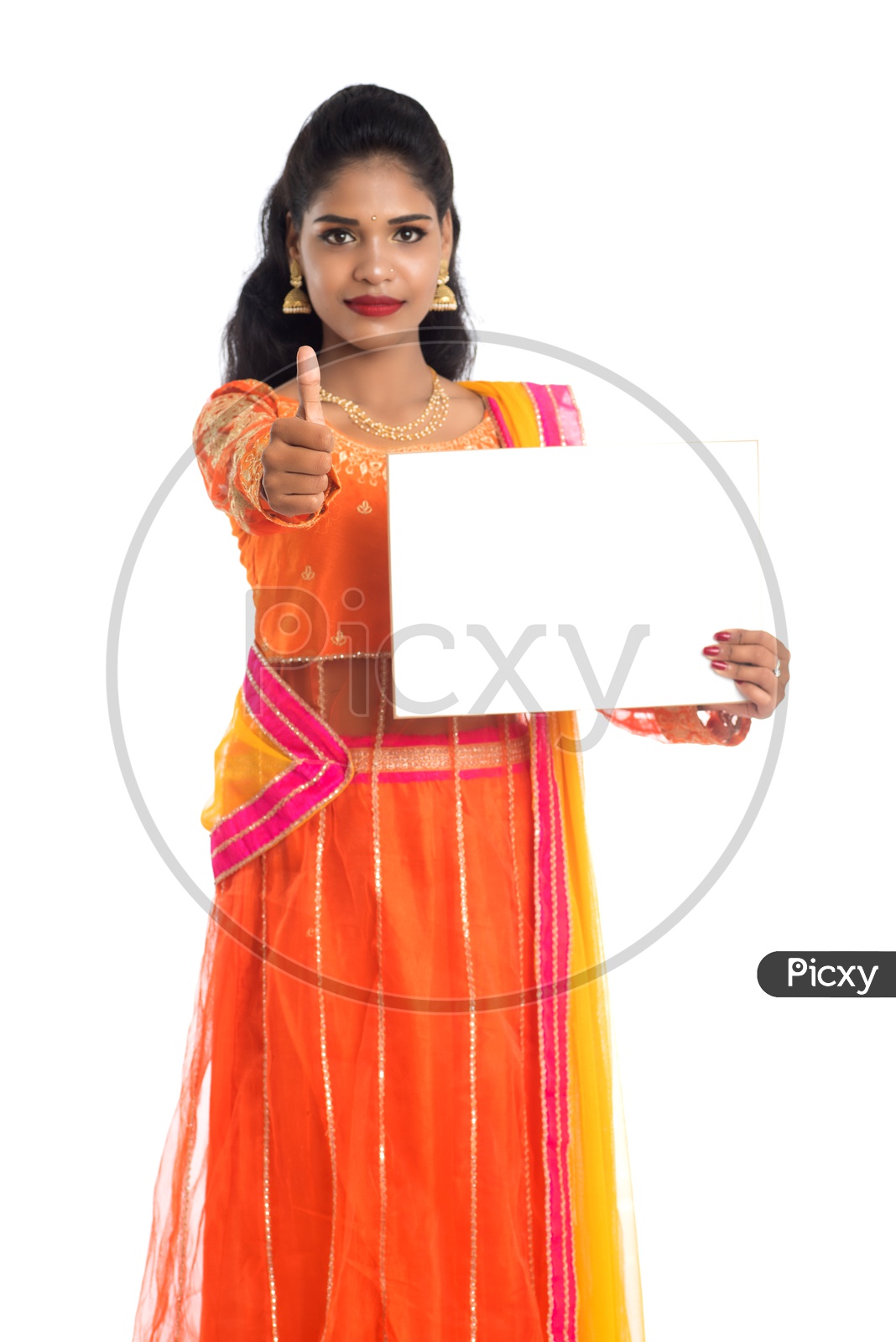 A young pretty Indian woman holding a blank white board or card with a thumbs up gesture