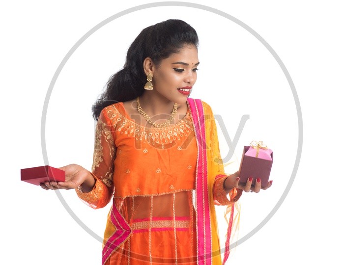 Young Traditional Indian Woman Holding Gift Boxes In hand With a Smile Face On an Isolated White Background