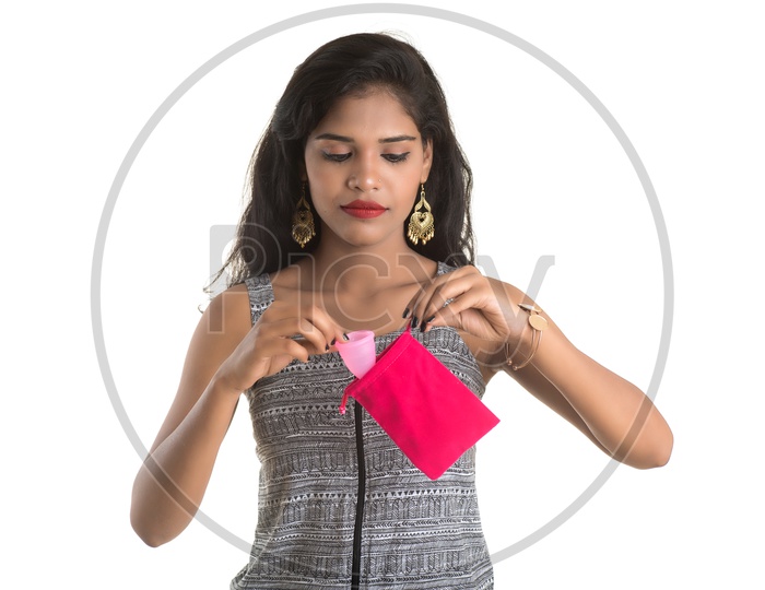 Indian woman putting a menstrual cup in pouch