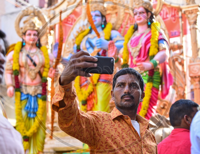 A man taking selfie with the Idols at Shri Rama Shobha yatra in Hyderabad