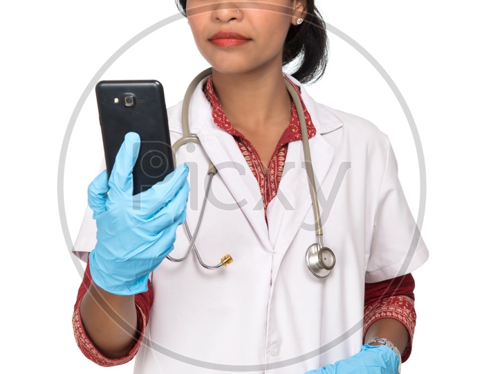 Indian Female Doctor checking her phone
