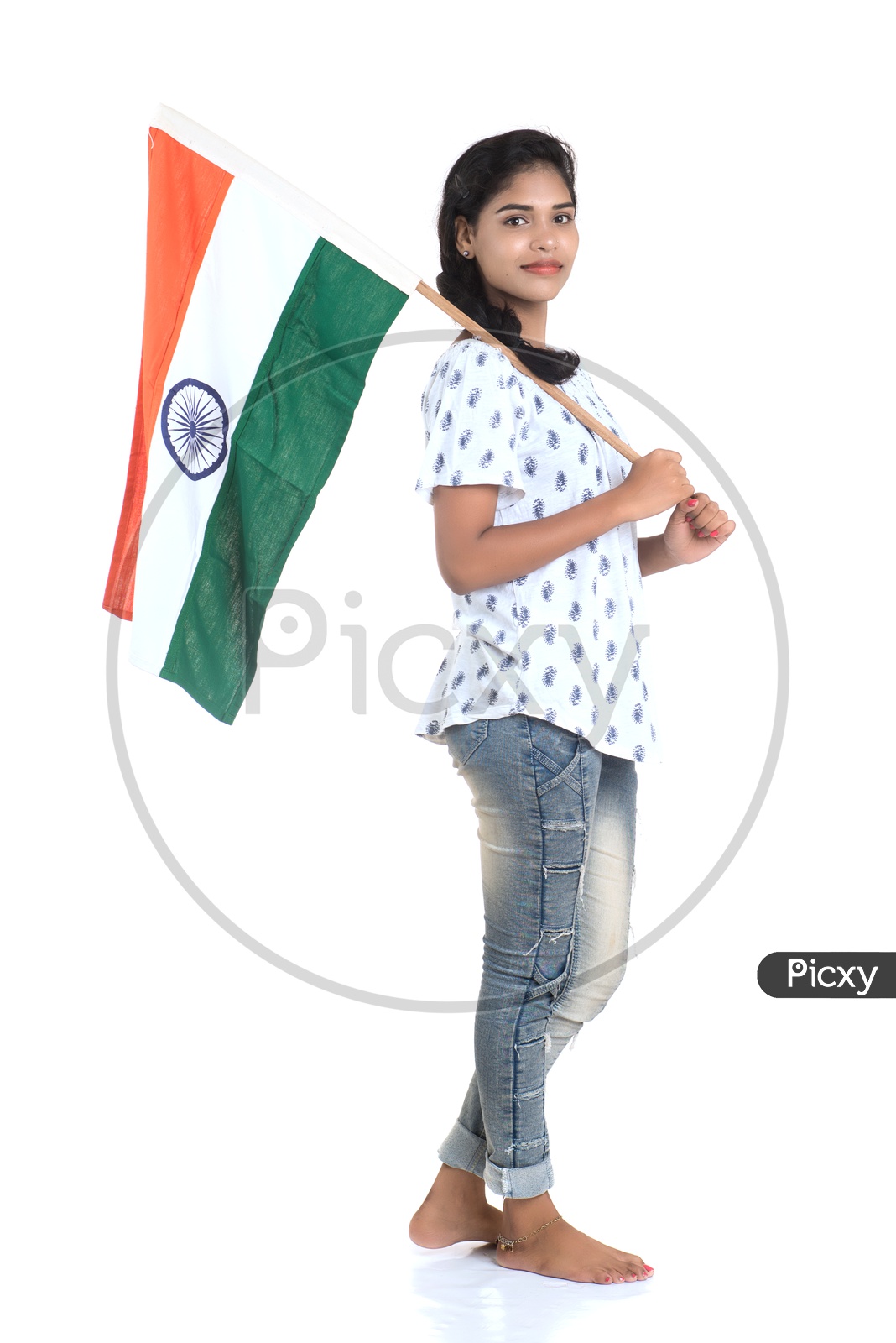 Girl Holding Indian National Flag or tricolour Flag In hand and Standing And Posing On a White Background