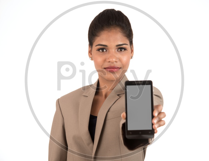Young beautiful woman holding blank screen smart phone on white background