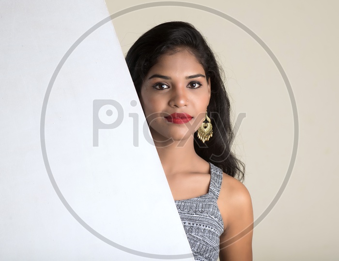 Indian woman holding an empty white board