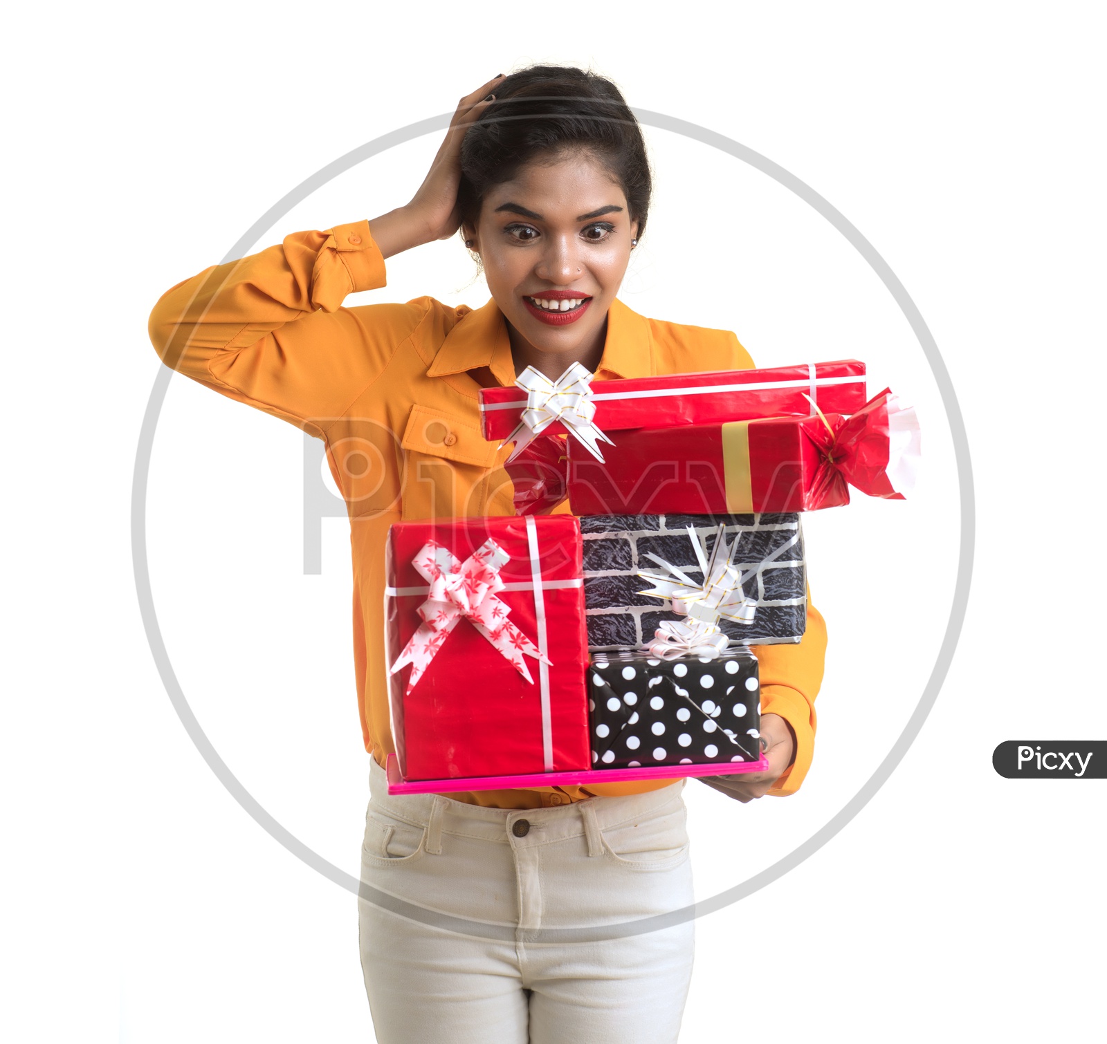 An Excited young Beautiful Indian Girl Holding Gift Box in Hand on an Isolated White Background
