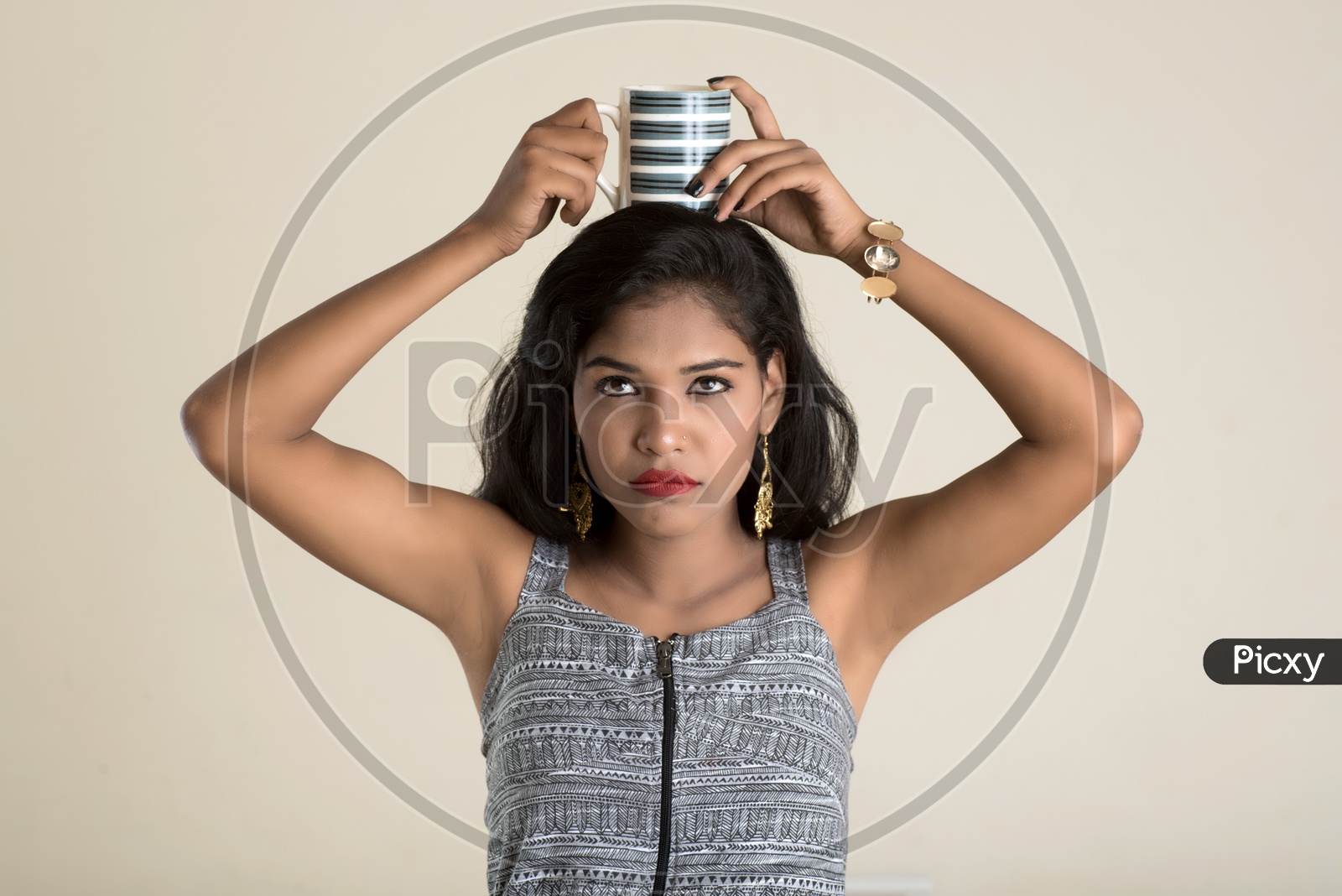 Indian woman holding a mug on her head