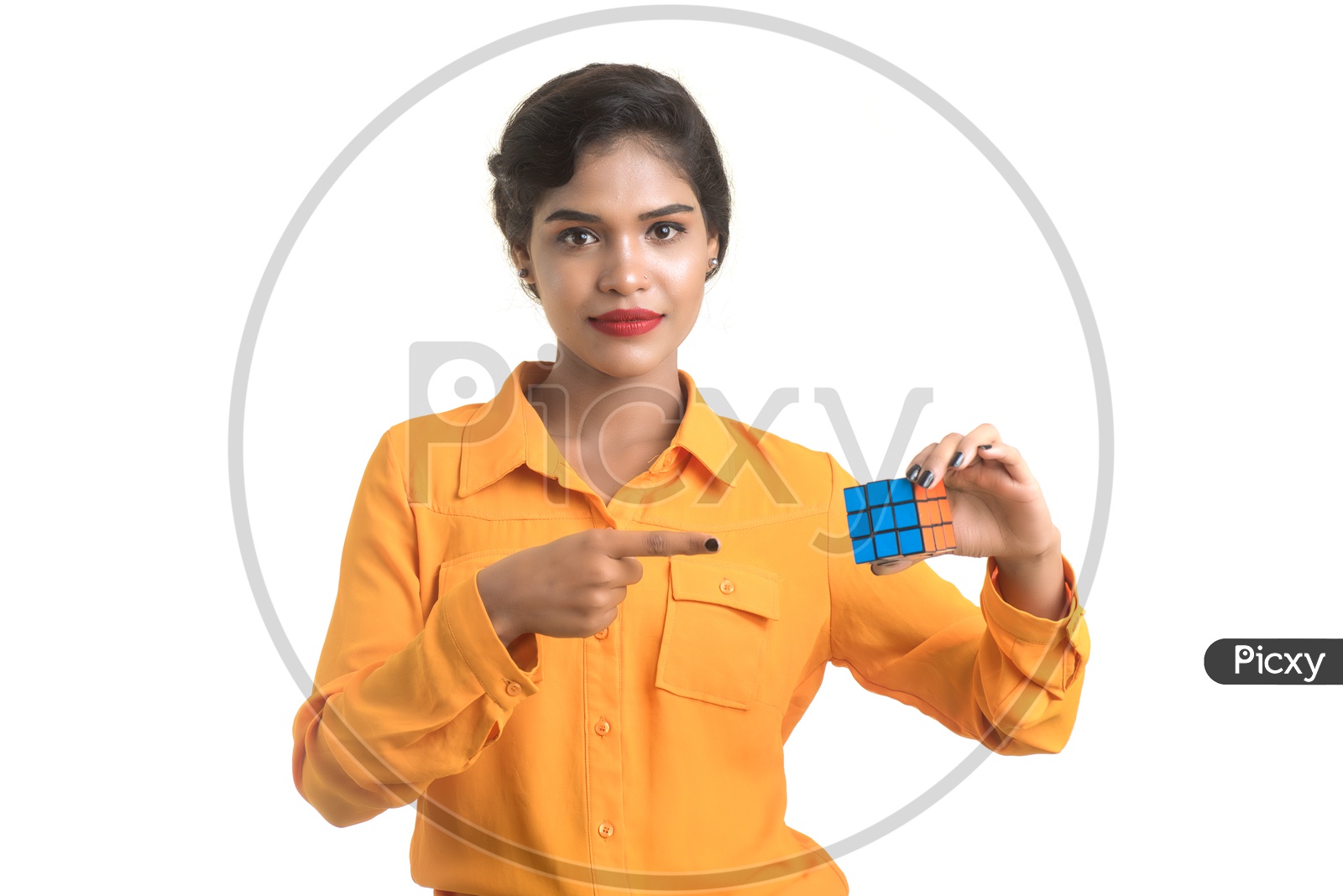Young Beautiful Girl With a Smile  Expression On Her Face and Holding Rubik's cube in hand on an isolated White Background