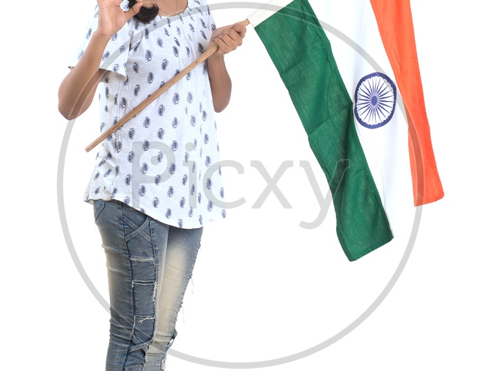 Young Indian Girl Holding Indian national Flag or Tri color Flag in hands And Posing Over a White Background
