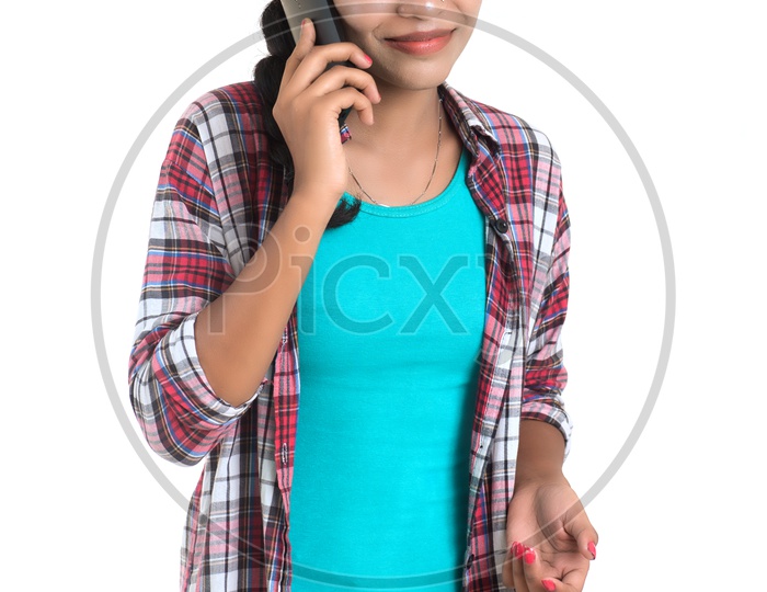 Young Indian Girl Talking In  Smart Phone On an Isolated White Background