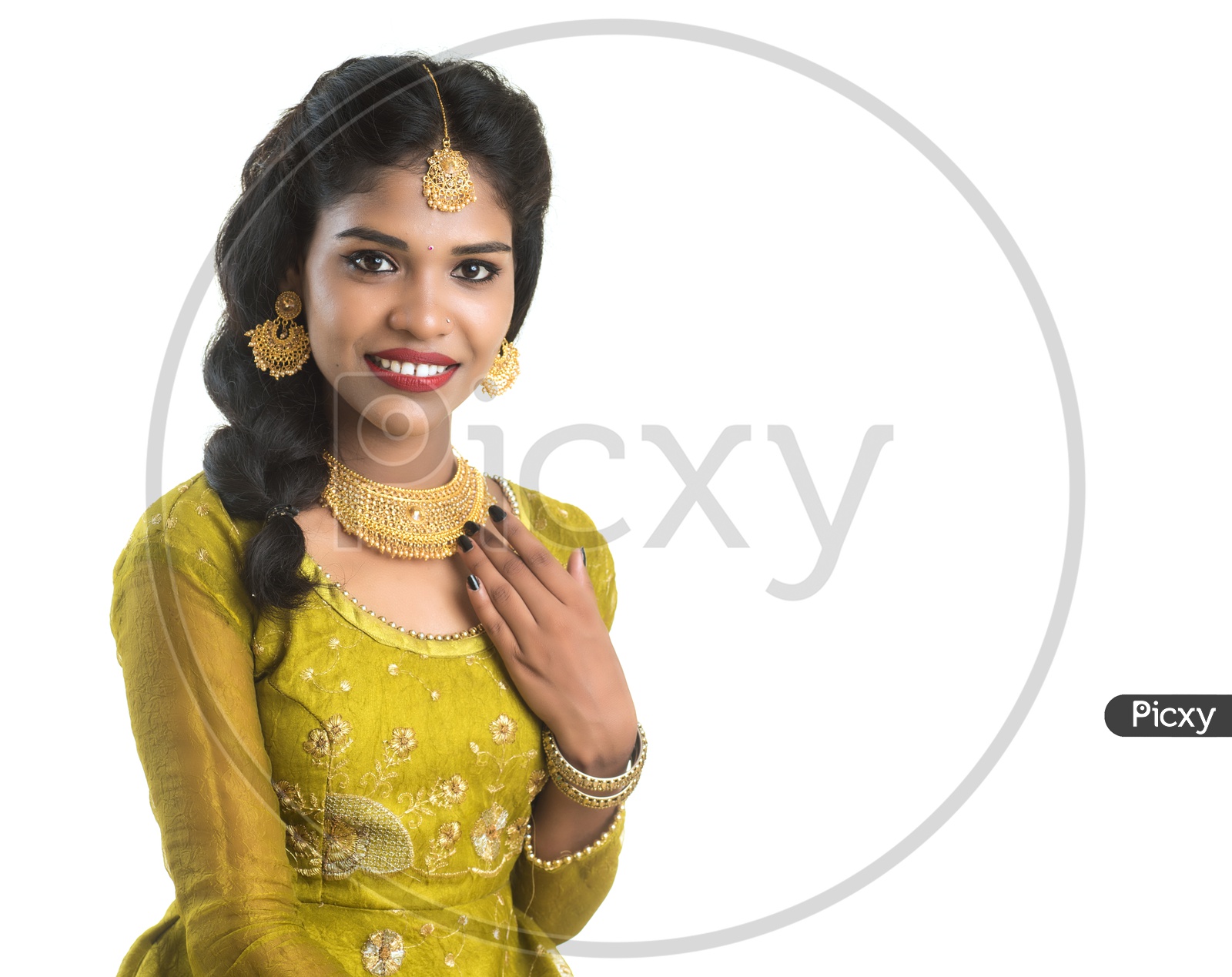 Portrait Of a Traditional  Beautiful Indian woman In Elegant Look Sitting and Posing Over White Background