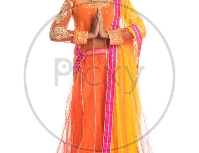 Portrait Of a Young Indian Woman Gesturing Namaste  With a Smiling Face and Posing On an Isolated White Background