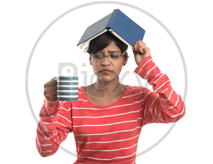 Pretty Young Girl Student Holding Book and With a Cup Of Coffee or Tea with an expression on face   and  Posing on an isolated White Background