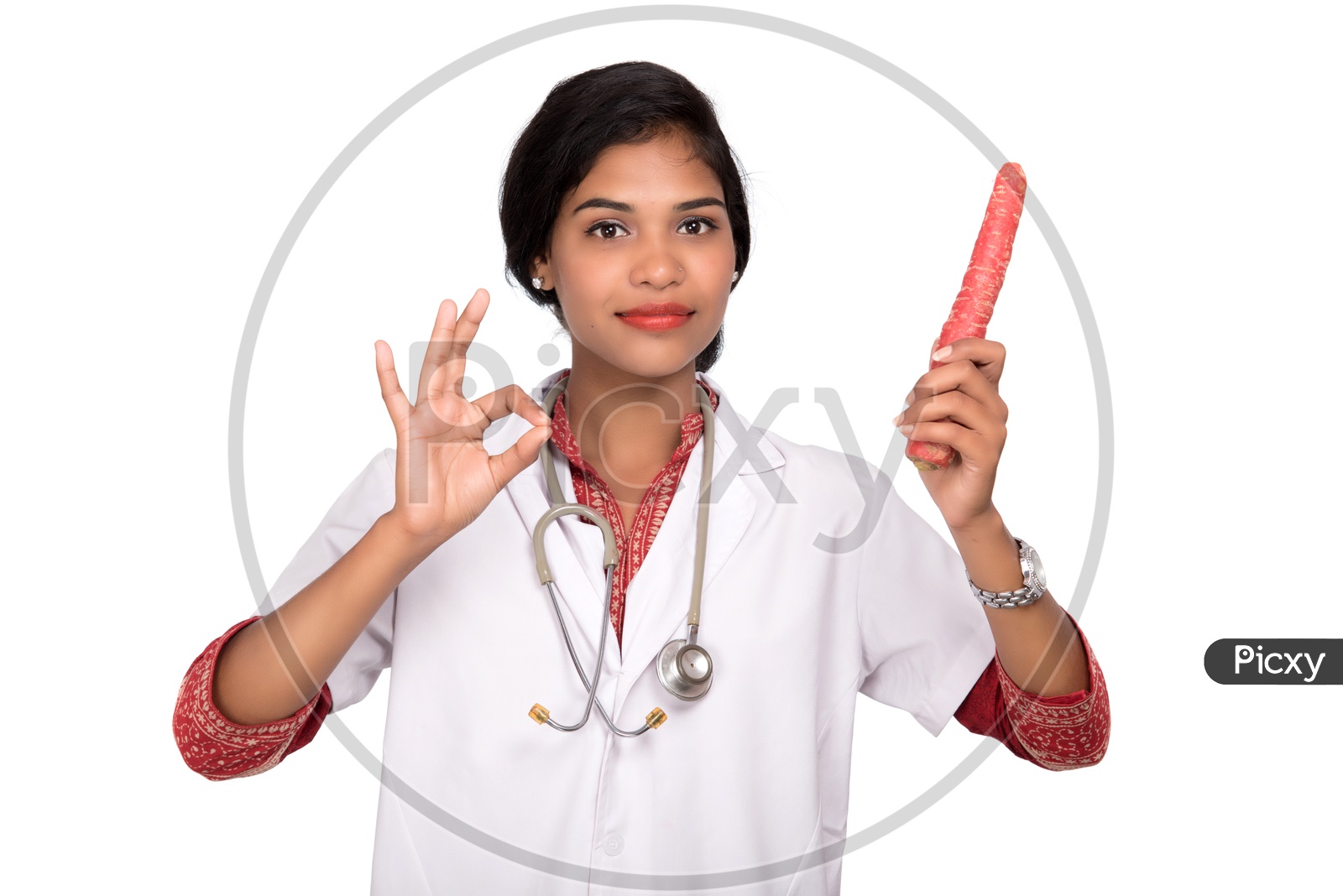 Indian Female Doctor holding carrot making a super sign