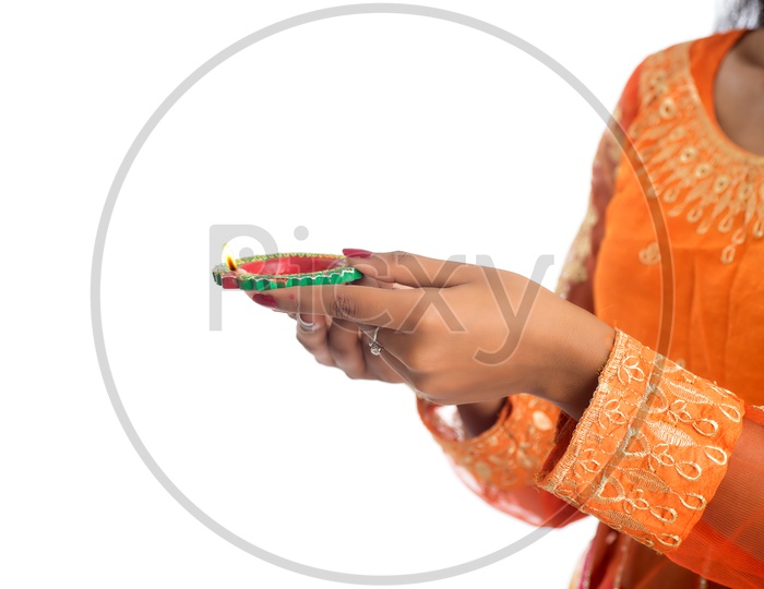 A young Indian woman holding Diya in hand