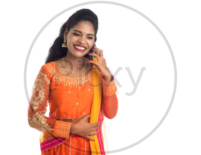 Beautiful Indian Woman wearing traditional dress talking on the phone