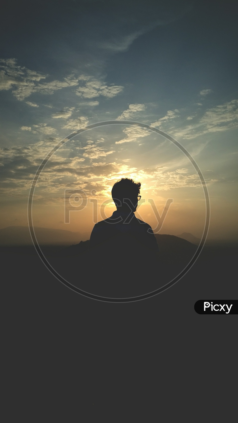 Silhouette Of a Man Over a Golden Hour Sky