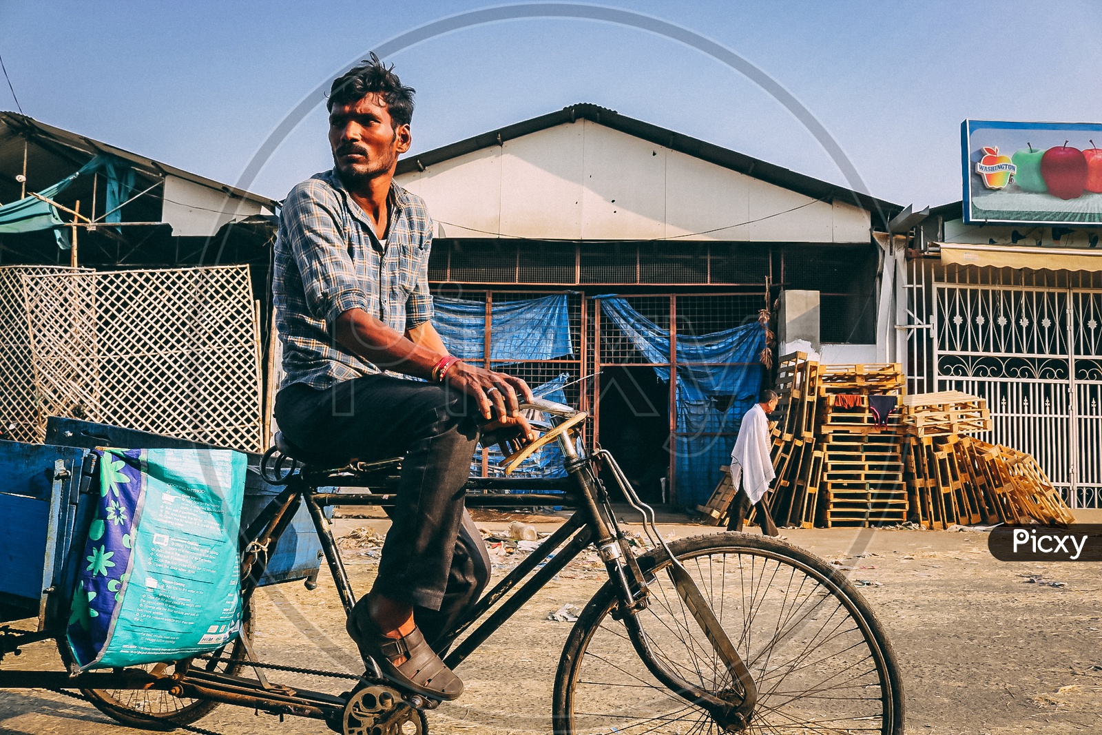 A street vendor going on a rikshaw