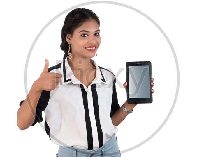 Pretty Young Indian Girl Showing Blank Smart Phone Screen and Showing The Space With an Expression  on an Isolated White Background