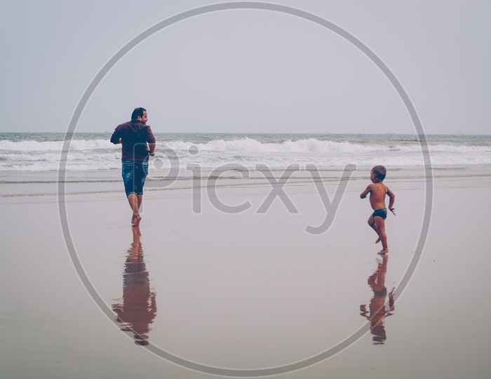 A Father And Sun Running In a Beach