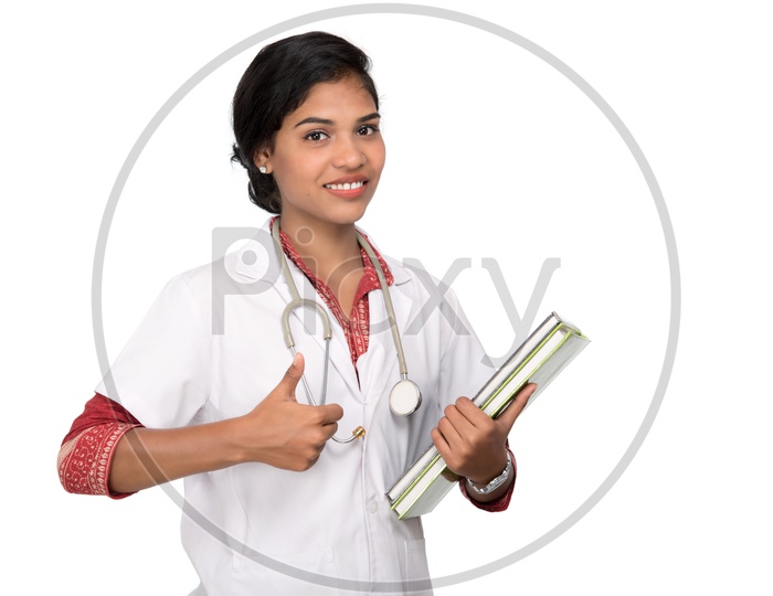 Young Lady Doctor With Stethoscope Over Neck And Holding Book In Hand On an Isolated White Background
