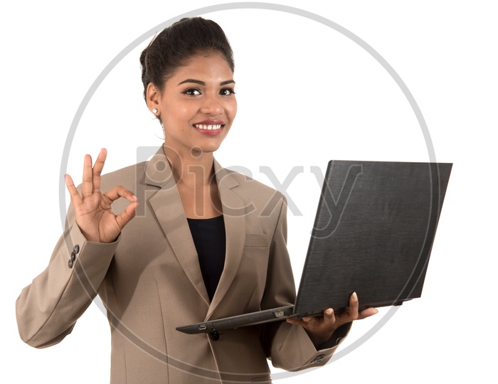 Young Indian business woman with a laptop making a super sign